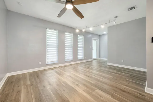 wooden floor in an empty room with a window