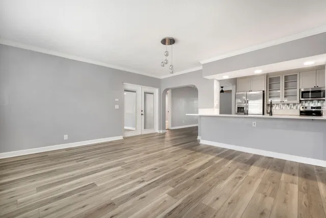 a view of a kitchen and an empty room