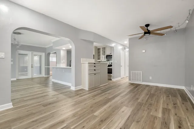 wooden floor in an empty room with a window