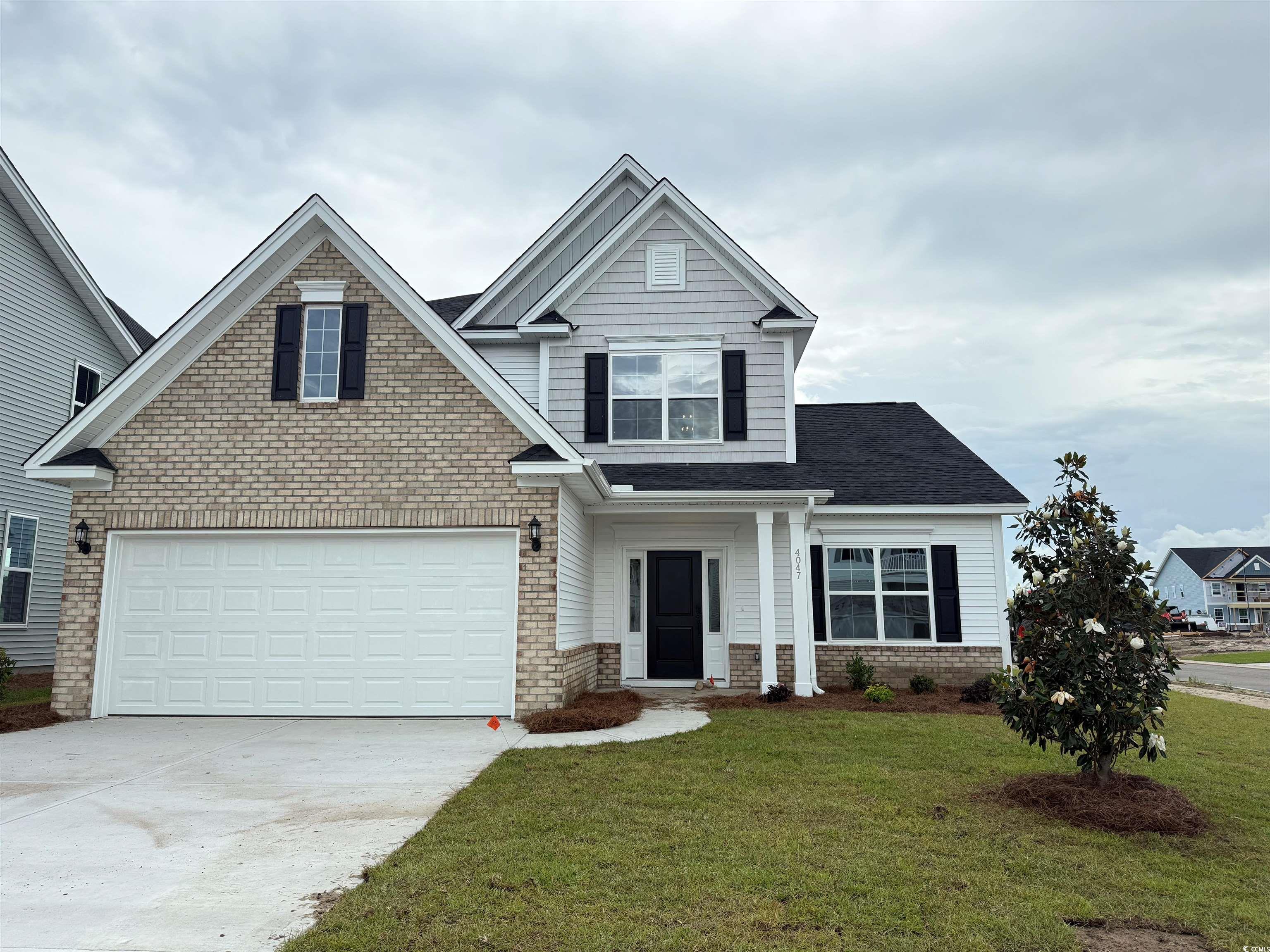 View of front of home featuring driveway, a front