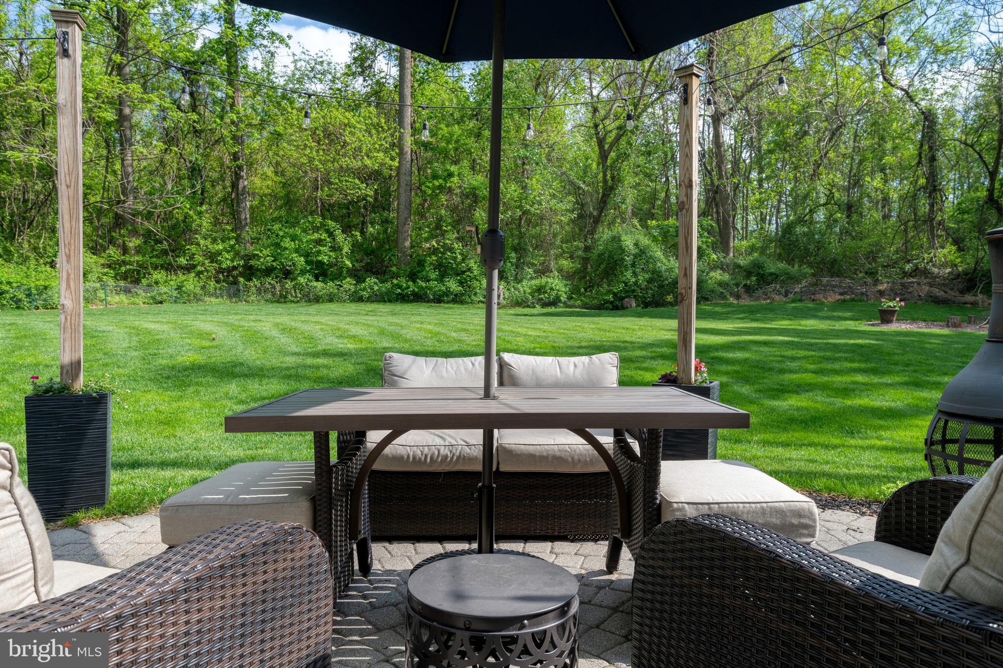 1156 Siddonsburg Road Mechanicsburg, PA 17055 - Photo 8 of 58 a view of a patio with a table chairs and a yard