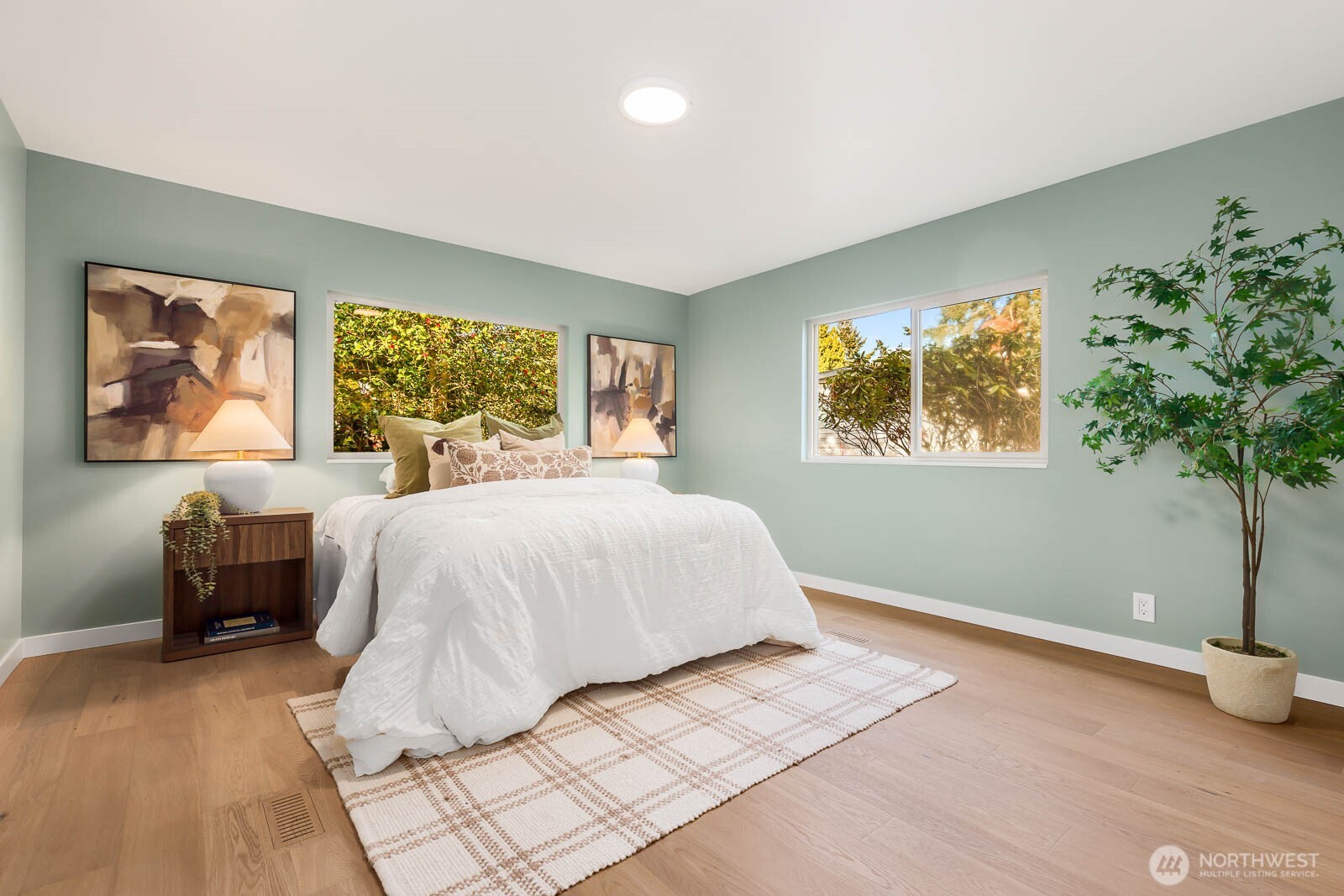 19425 Hollyhills Drive Northeast Bothell, WA 98011 - Photo 14 of 26 a bedroom with a large bed and a potted plant