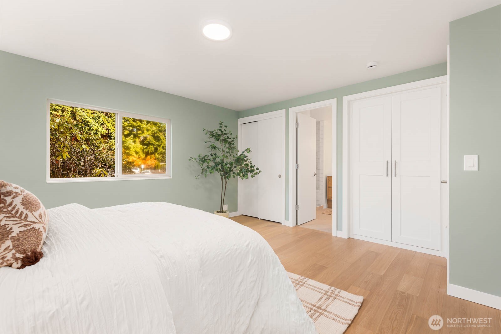 19425 Hollyhills Drive Northeast Bothell, WA 98011 - Photo 16 of 26 a bedroom with a large bed and a window