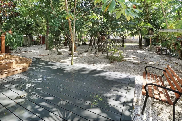 an aerial view of a house with a yard and garden