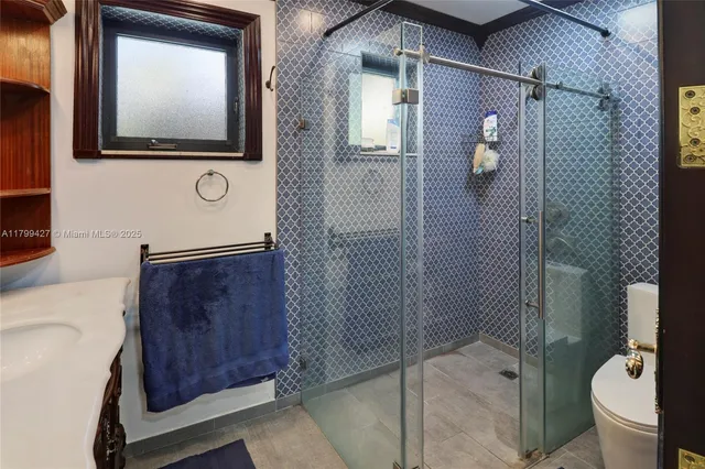 a view of a wooden bench with a flower garden