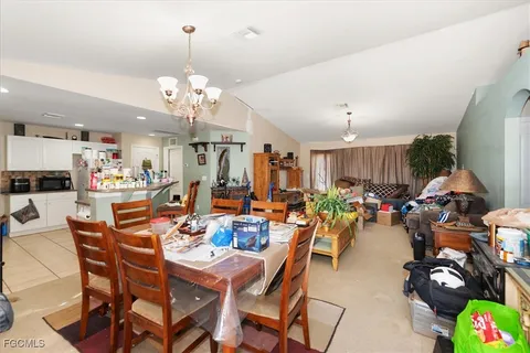a view of a dining room with furniture and a chandelier