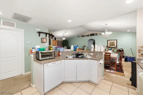 a kitchen with stainless steel appliances kitchen island granite countertop a sink and cabinets