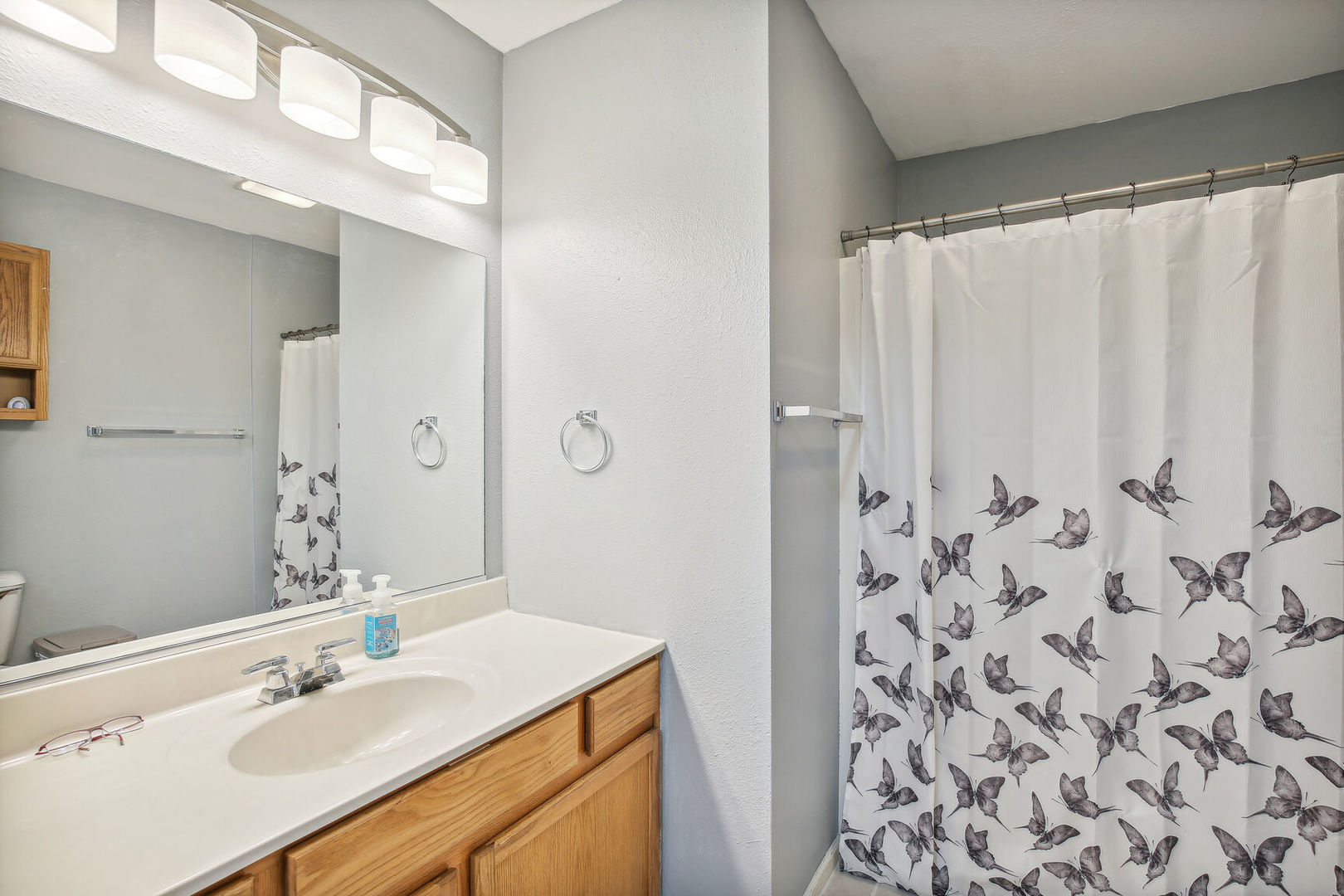 2404 Windward Boulevard, Unit 104 Champaign, IL 61821 - Photo 13 of 14 a bathroom with a sink and a mirror