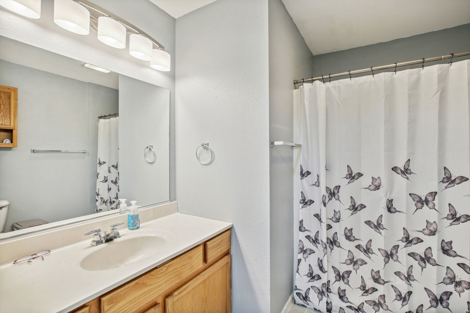 2404 Windward Boulevard, Unit 104 Champaign, IL 61821 - Photo 14 of 14 a bathroom with a sink and a mirror