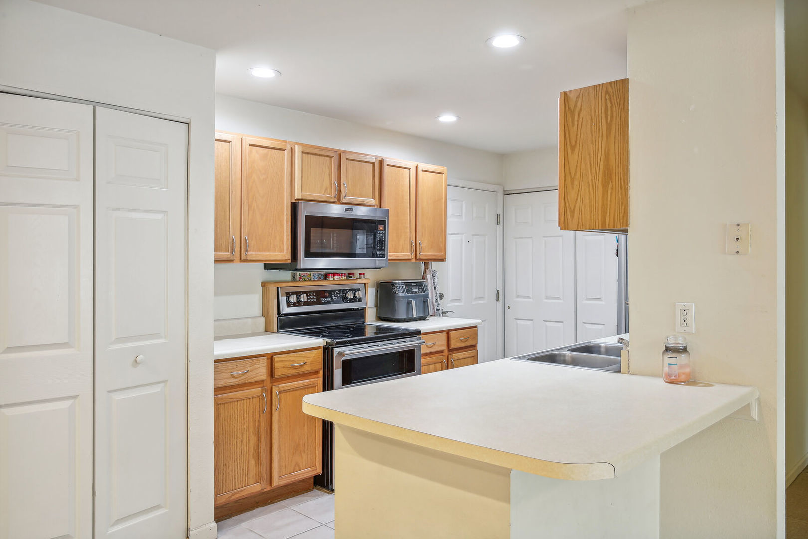 2404 Windward Boulevard, Unit 104 Champaign, IL 61821 - Photo 4 of 14 a kitchen with stainless steel appliances a stove microwave and sink