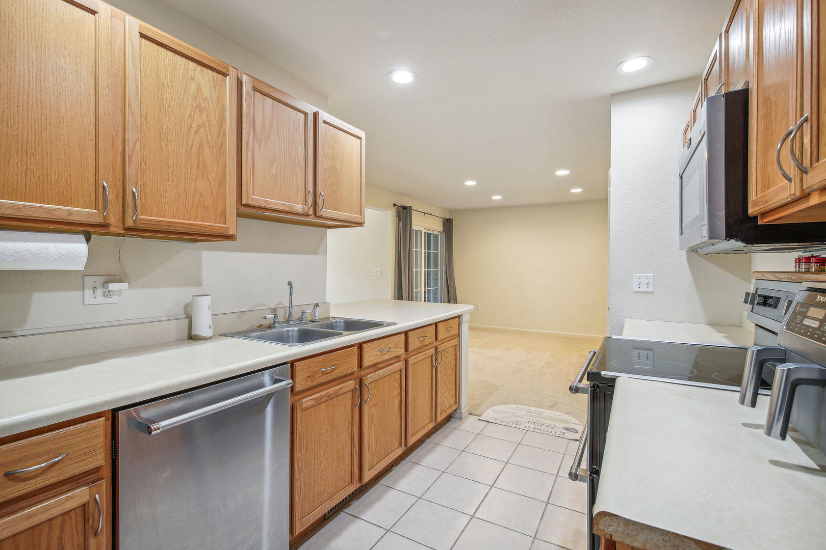 2404 Windward Boulevard, Unit 104 Champaign, IL 61821 - Photo 5 of 14 a kitchen with a sink and cabinets