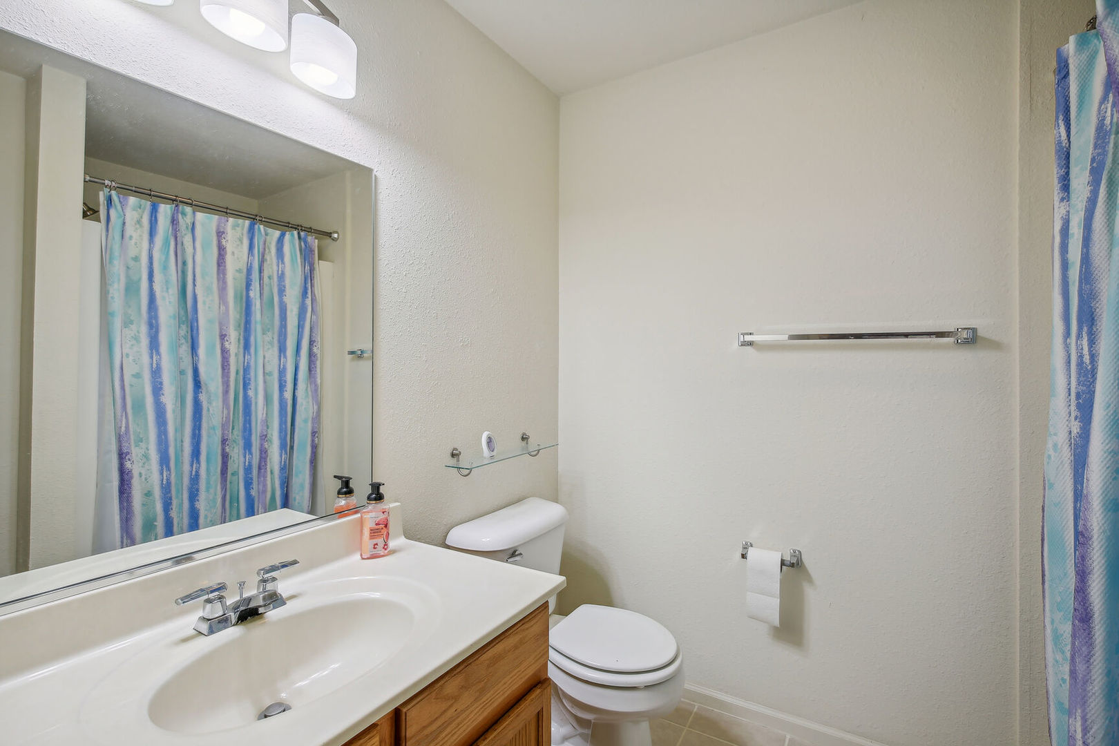 2404 Windward Boulevard, Unit 104 Champaign, IL 61821 - Photo 9 of 14 a bathroom with a sink toilet and mirror