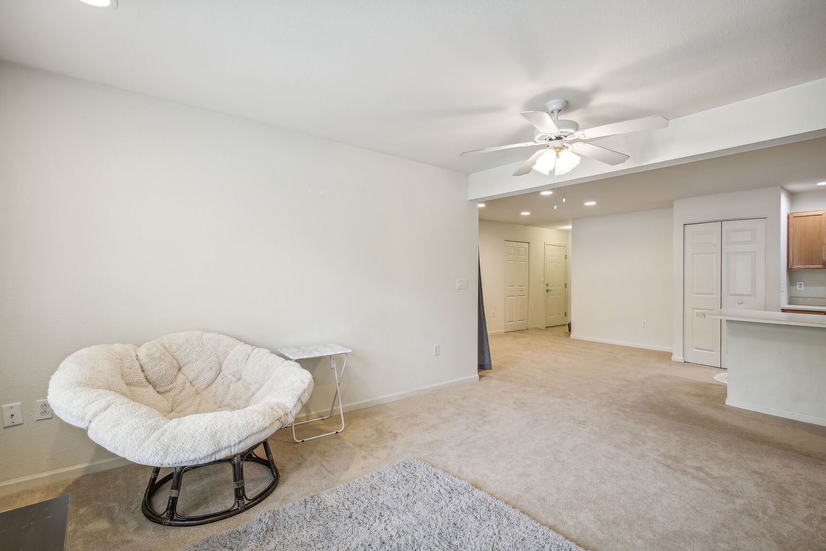 2404 Windward Boulevard, Unit 104 Champaign, IL 61821 - Photo 10 of 14 a view of a livingroom with furniture and a ceiling fan