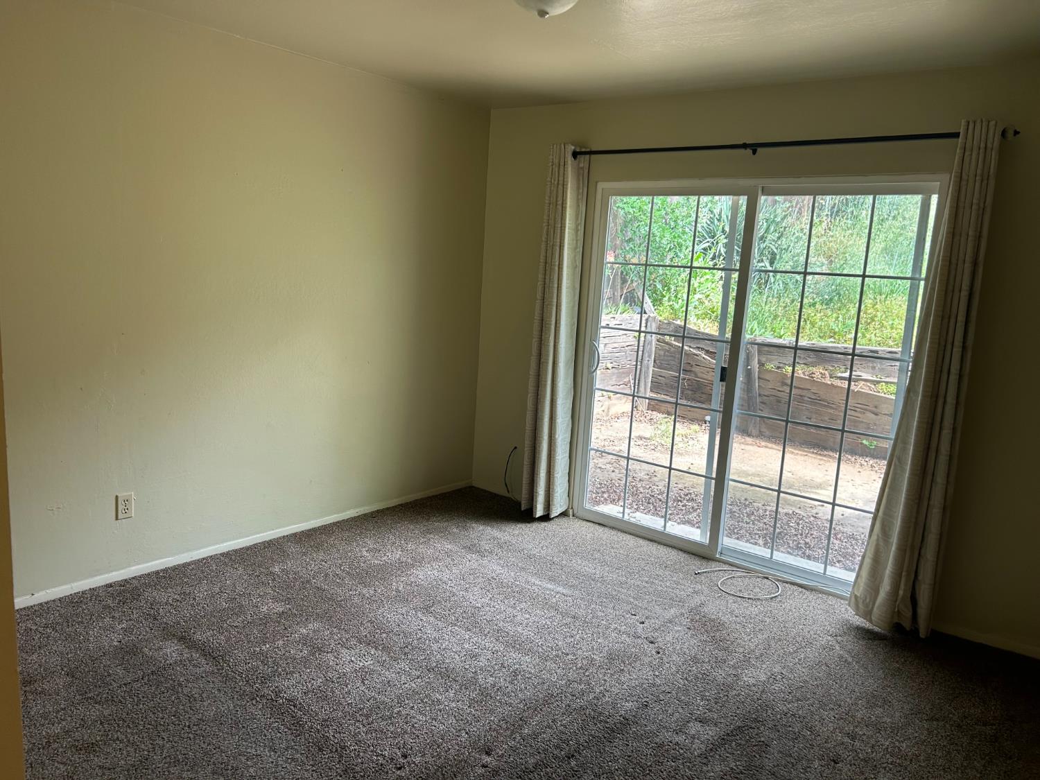 413 Shakeley Lane Ione, CA 95640 - Photo 3 of 11 a view of an empty room with wooden floor and a window