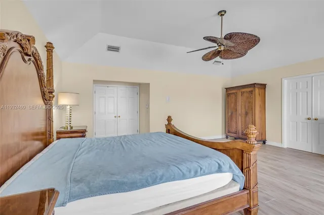 a bathroom with a granite countertop sink mirror vanity and toilet
