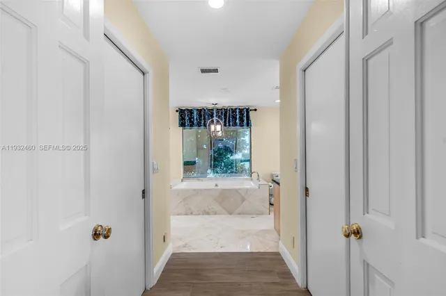 a view of a hallway with wooden floor and a fireplace