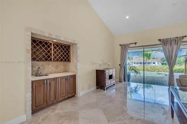 a living room with fireplace furniture and a floor to ceiling window