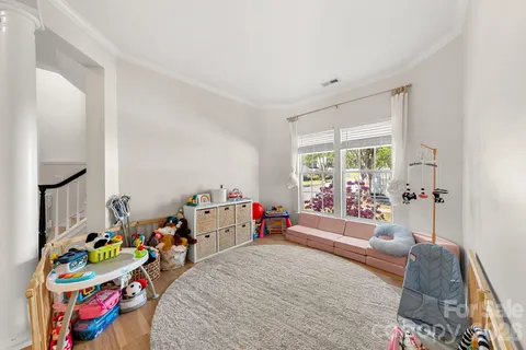 a bed room with furniture and a wooden floor