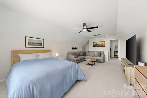 a bedroom with bed and tv