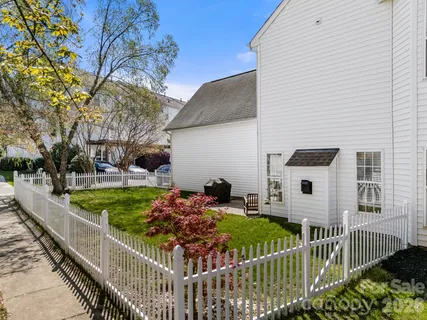 a view of a house with wooden fence