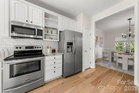 a kitchen with stainless steel appliances a stove microwave and a refrigerator