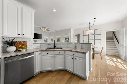 a kitchen with a sink cabinets and window