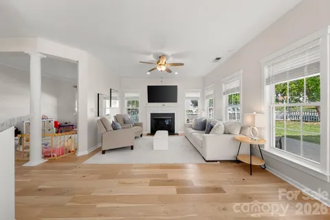 a living room with furniture a fireplace and a flat screen tv