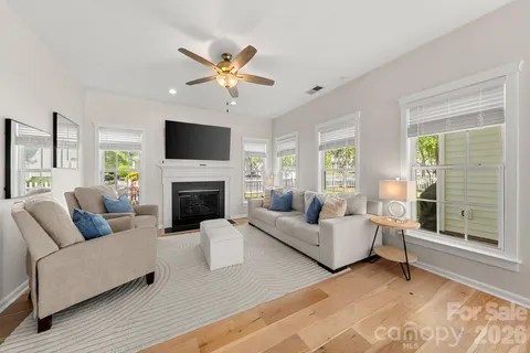 a living room with furniture a fireplace and a flat screen tv