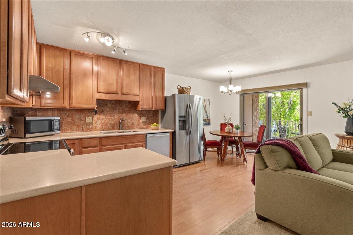 5525 East Thomas Road, Unit O12 Phoenix, AZ 85018 - Photo 4 of 27 a kitchen with stainless steel appliances granite countertop a refrigerator a sink a stove and a microwave