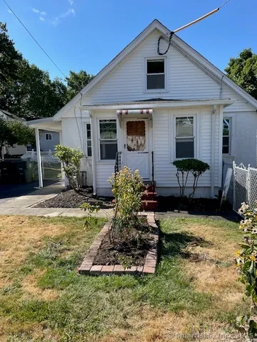 a front view of house with yard and outdoor seating