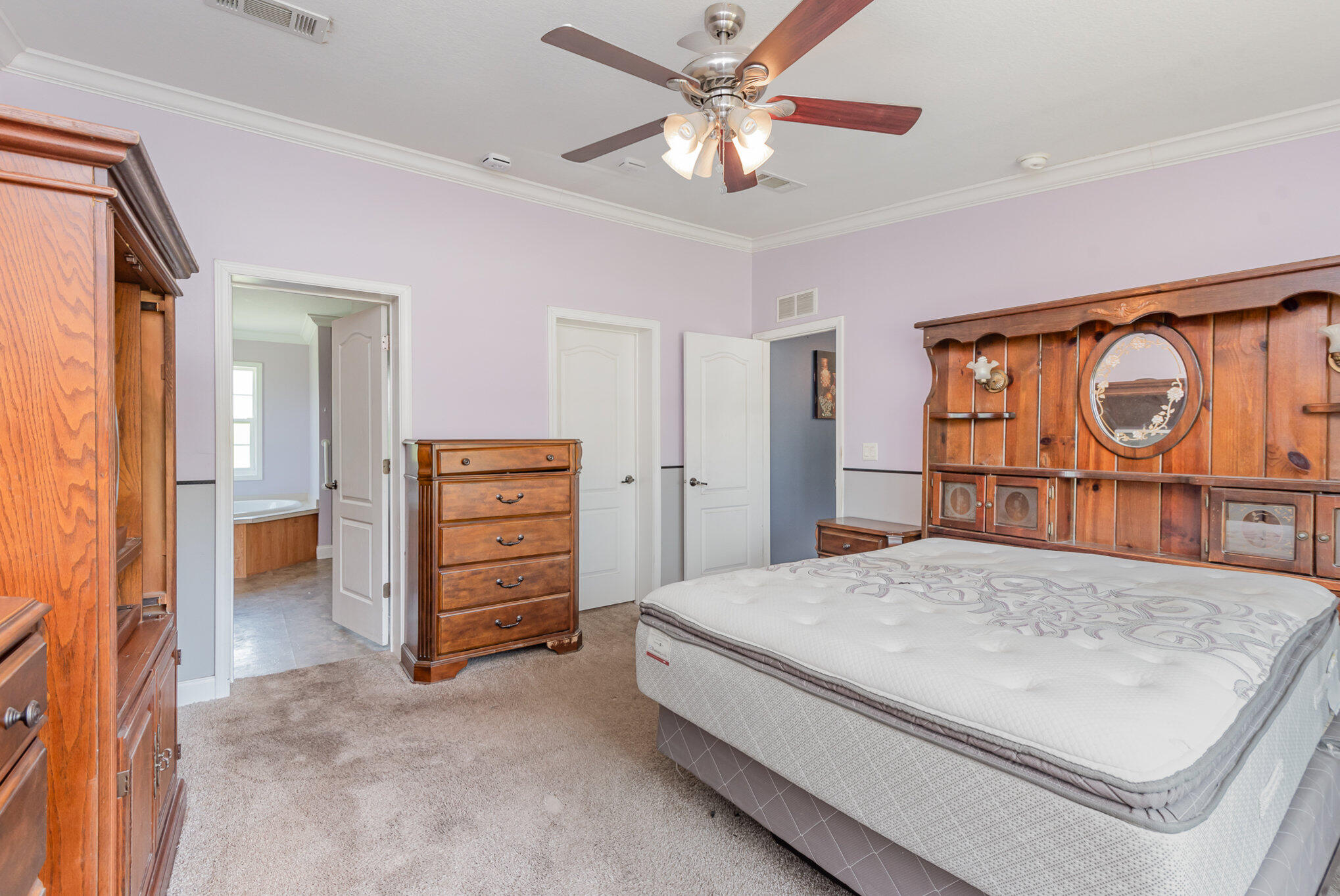 4850 Harrison Road Mims, FL 32754 - Photo 11 of 28 a bedroom with a bed and a dresser