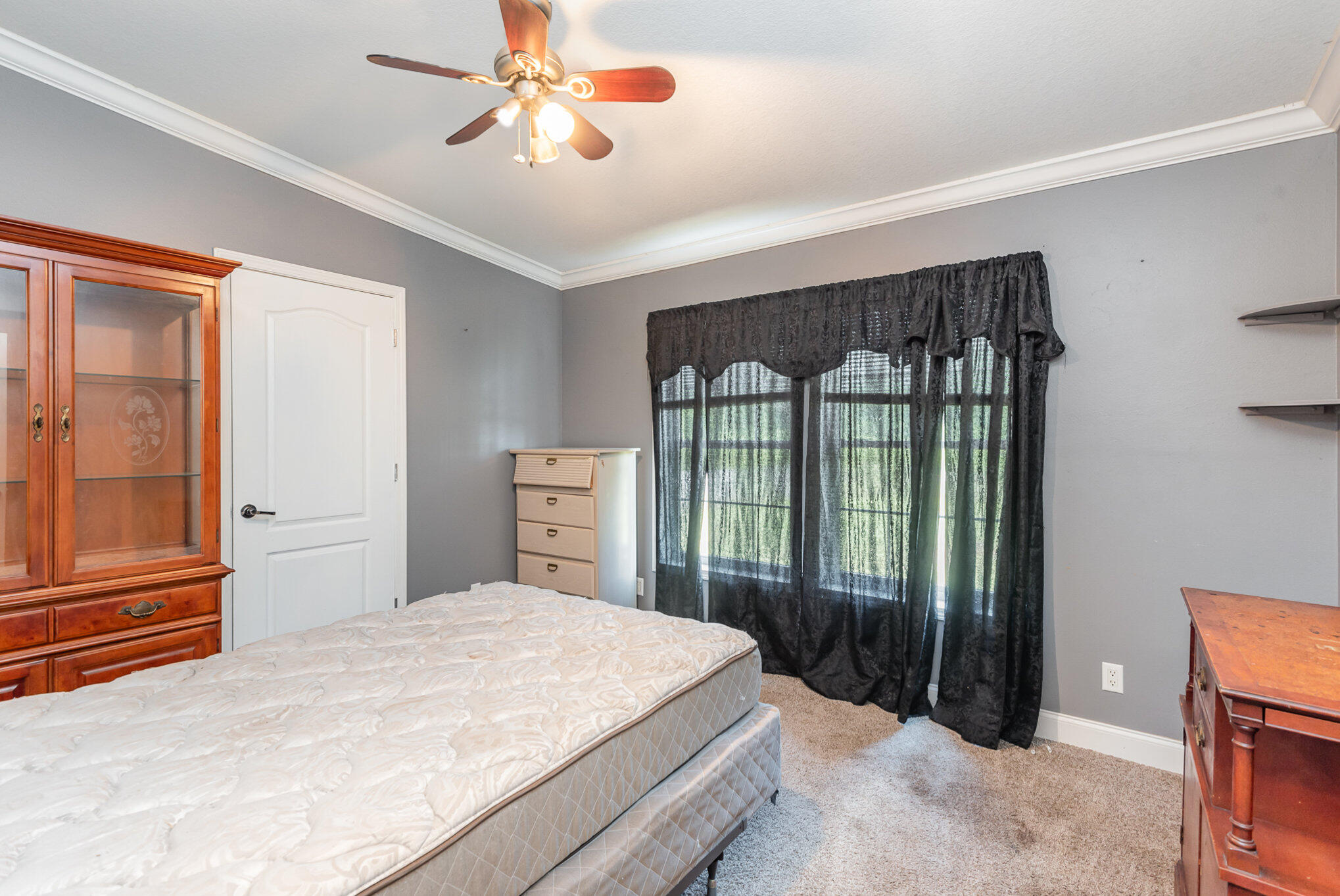 4850 Harrison Road Mims, FL 32754 - Photo 15 of 28 a bedroom with a large bed and a chandelier