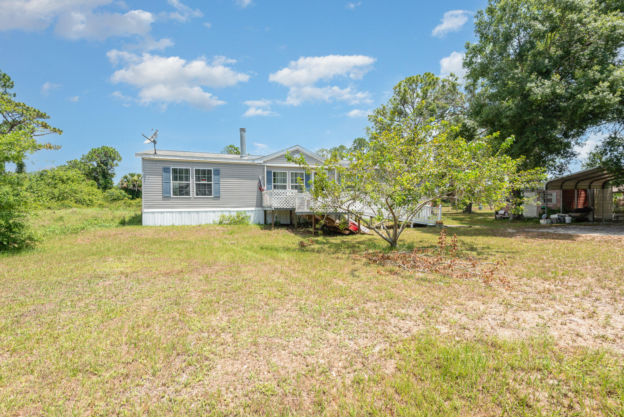 4850 Harrison Road Mims, FL 32754 - Photo 2 of 28 a view of a house with a yard