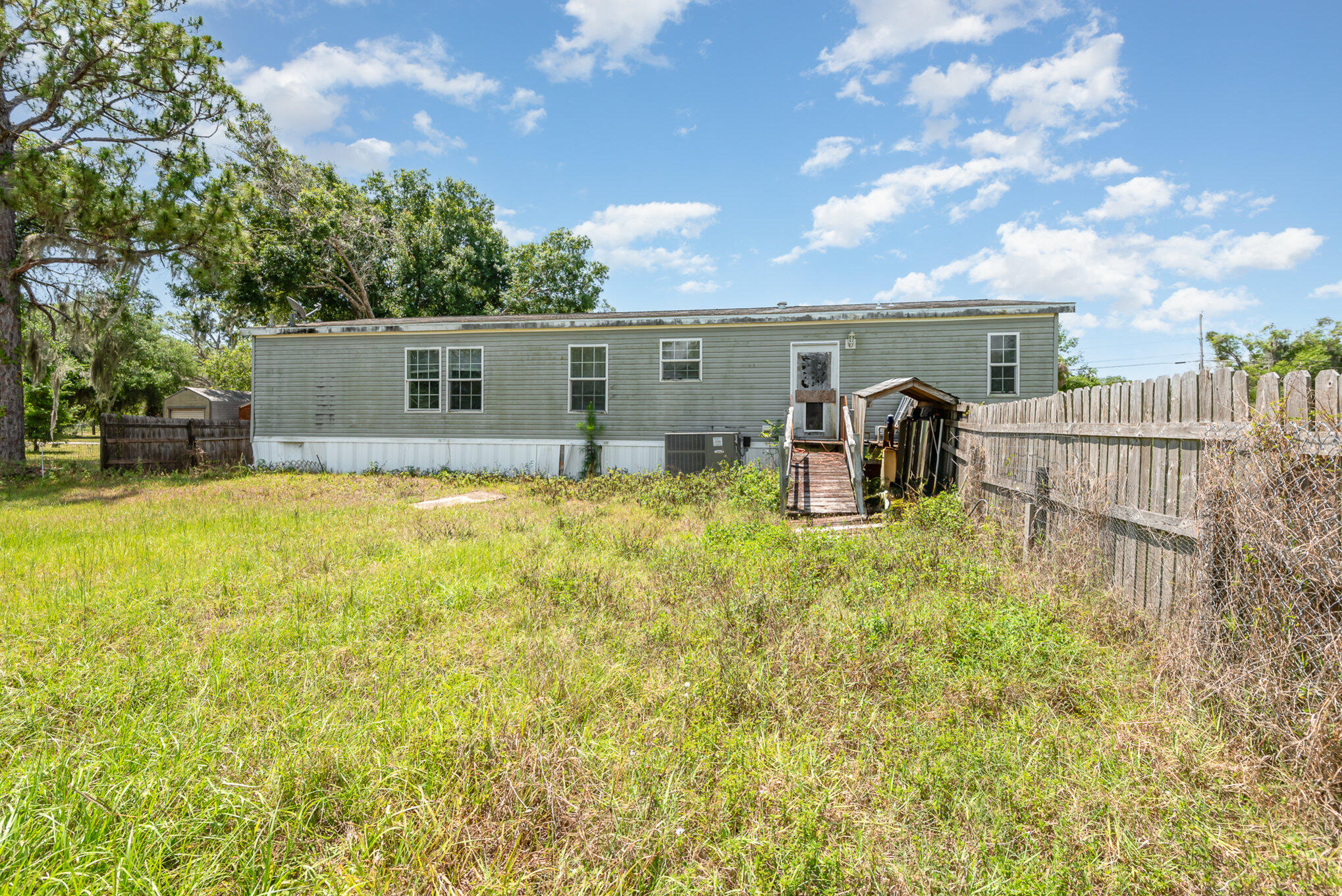 4850 Harrison Road Mims, FL 32754 - Photo 23 of 28 a house view with swimming pool and sitting space