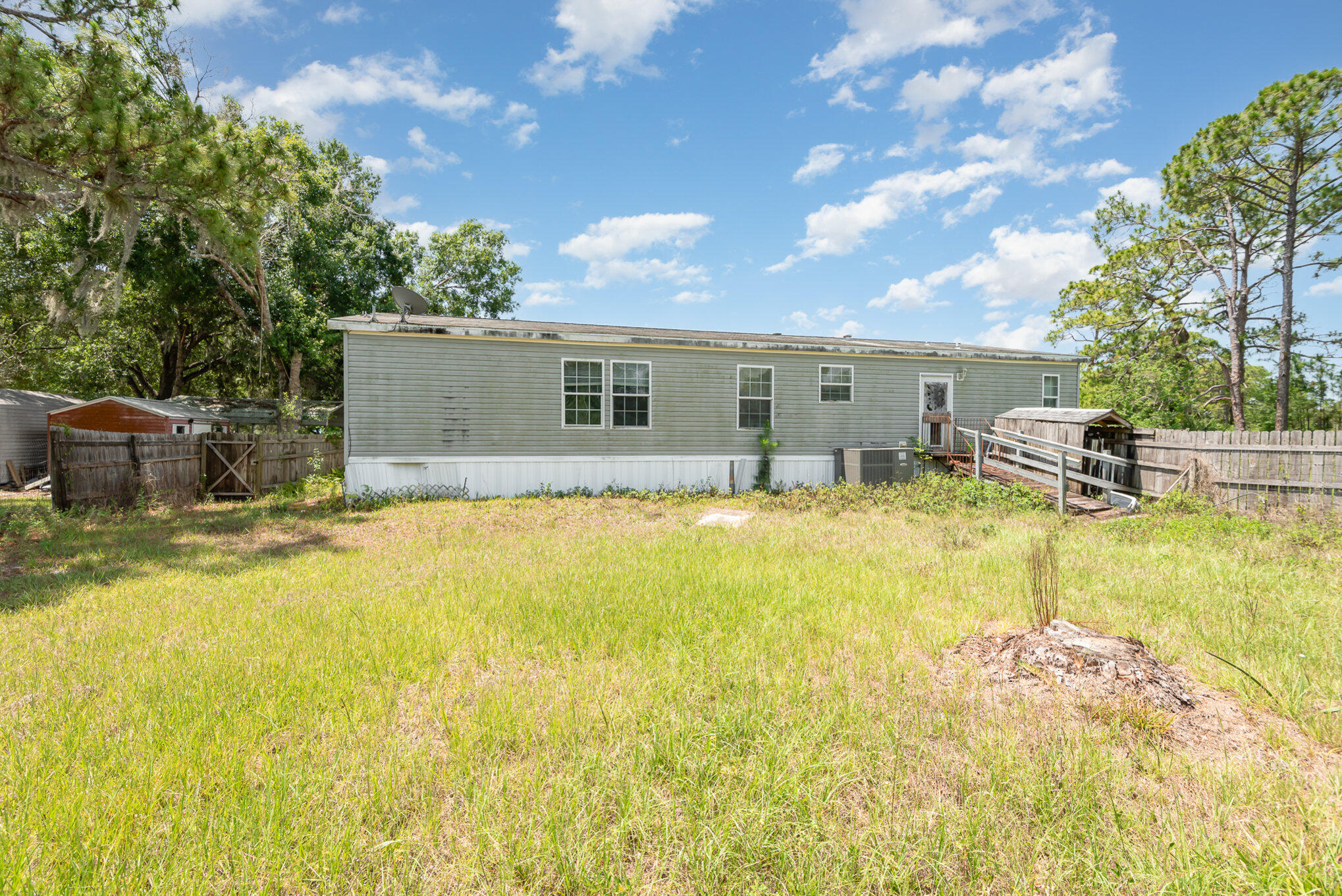 4850 Harrison Road Mims, FL 32754 - Photo 24 of 28 a swimming pool with outdoor seating and yard