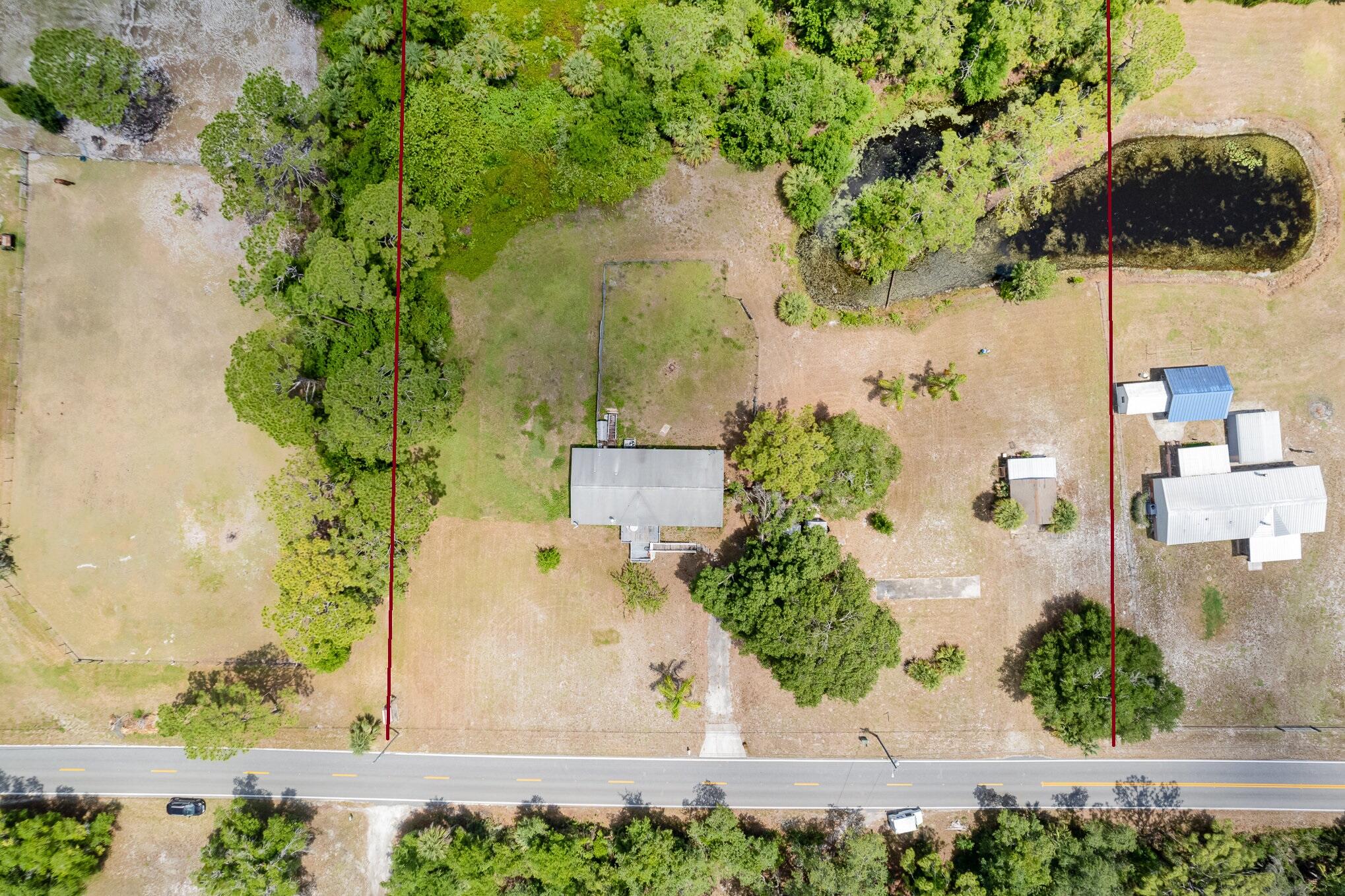 4850 Harrison Road Mims, FL 32754 - Photo 3 of 28 an aerial view of a house with a yard and large trees