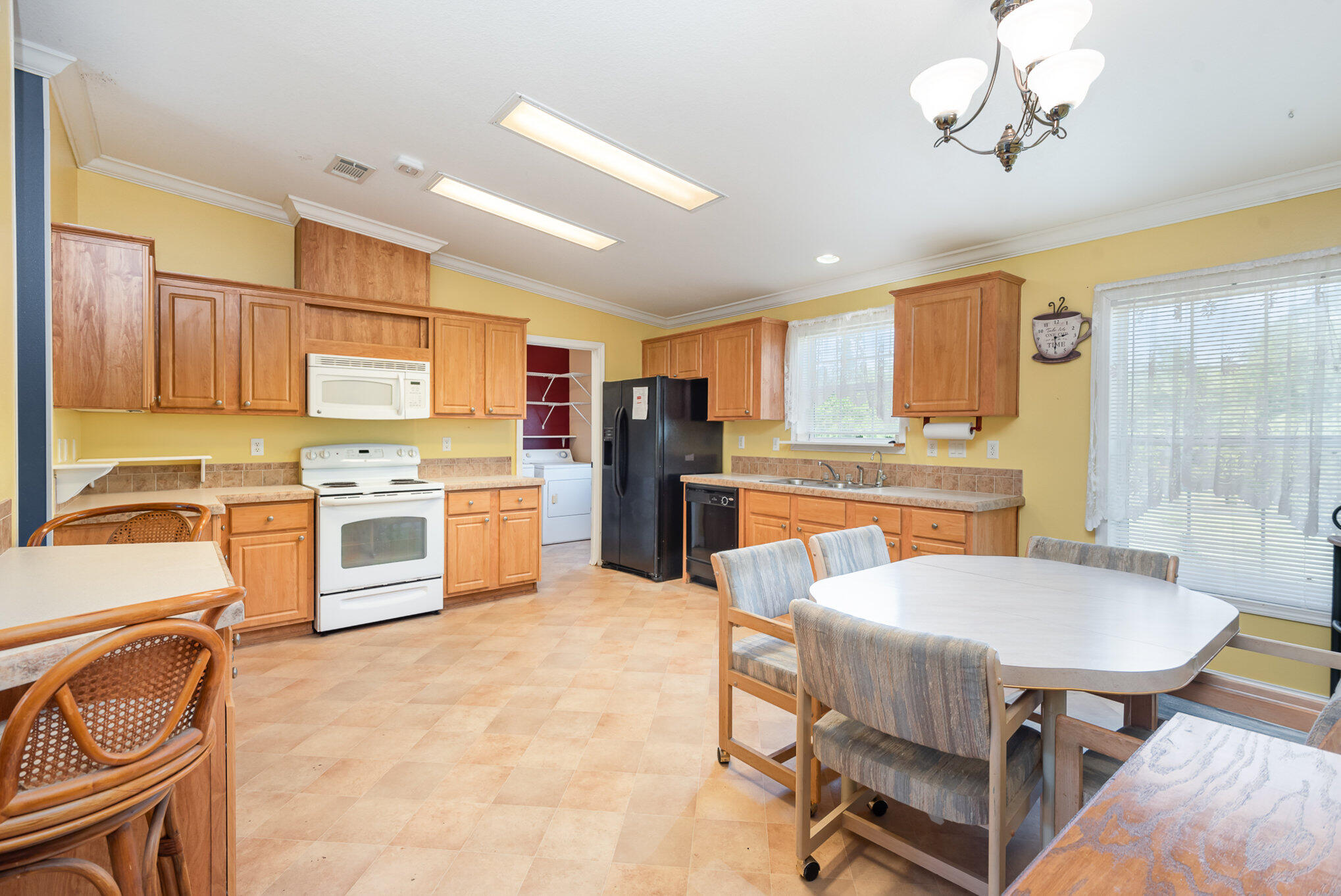 4850 Harrison Road Mims, FL 32754 - Photo 7 of 28 a kitchen with a table chairs stove and refrigerator