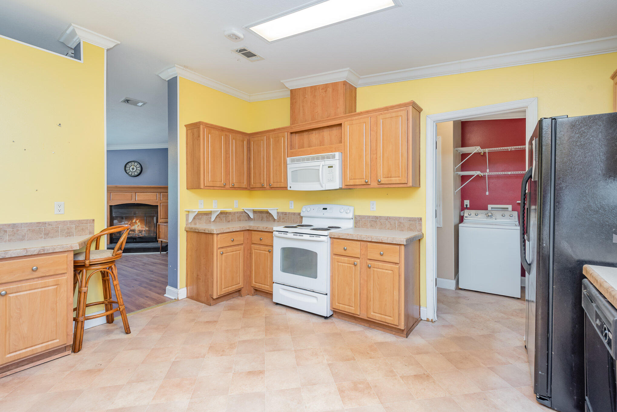 4850 Harrison Road Mims, FL 32754 - Photo 9 of 28 a kitchen with stainless steel appliances granite countertop a stove refrigerator and cabinets