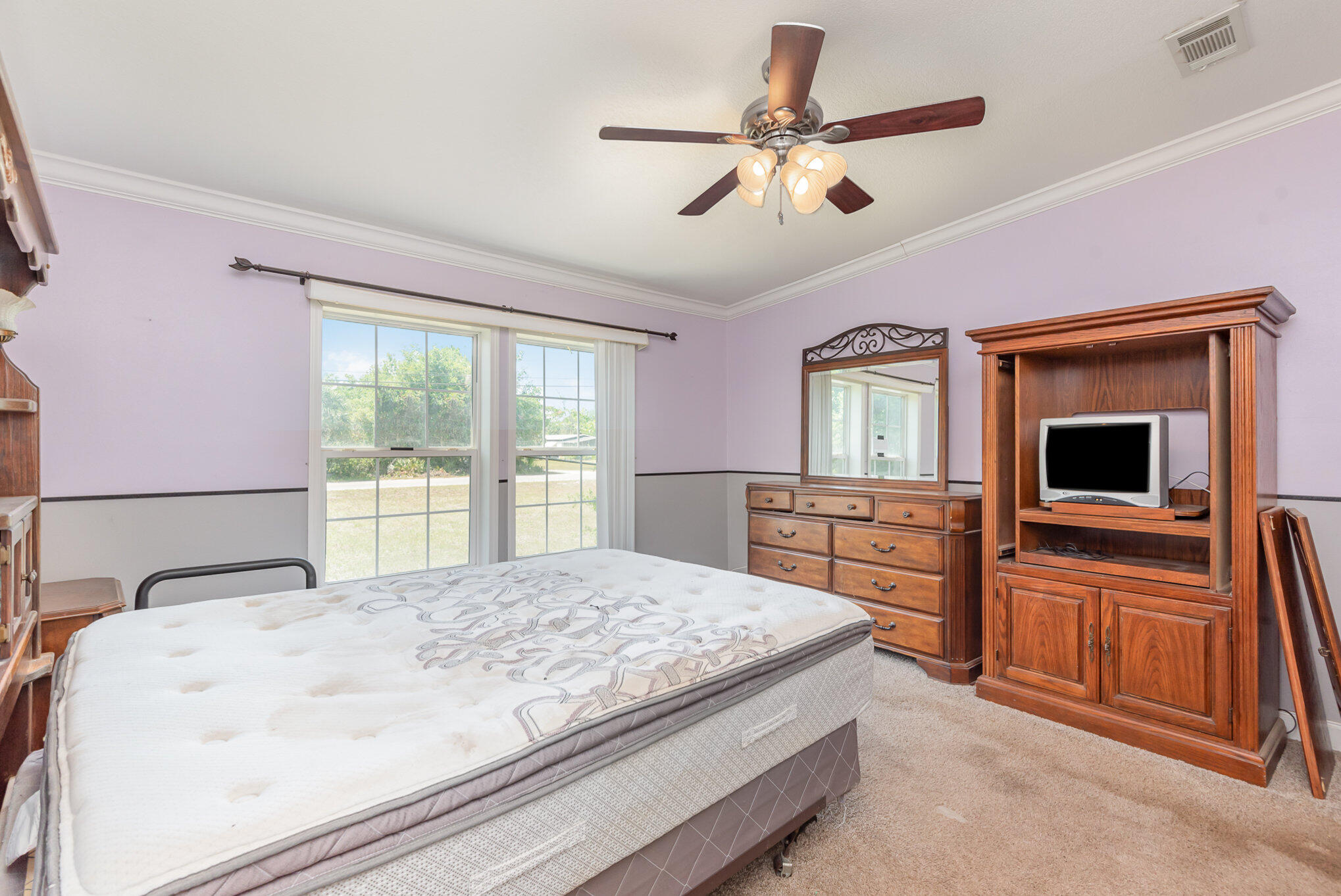 4850 Harrison Road Mims, FL 32754 - Photo 10 of 28 a bedroom with a large bed and a flat screen tv