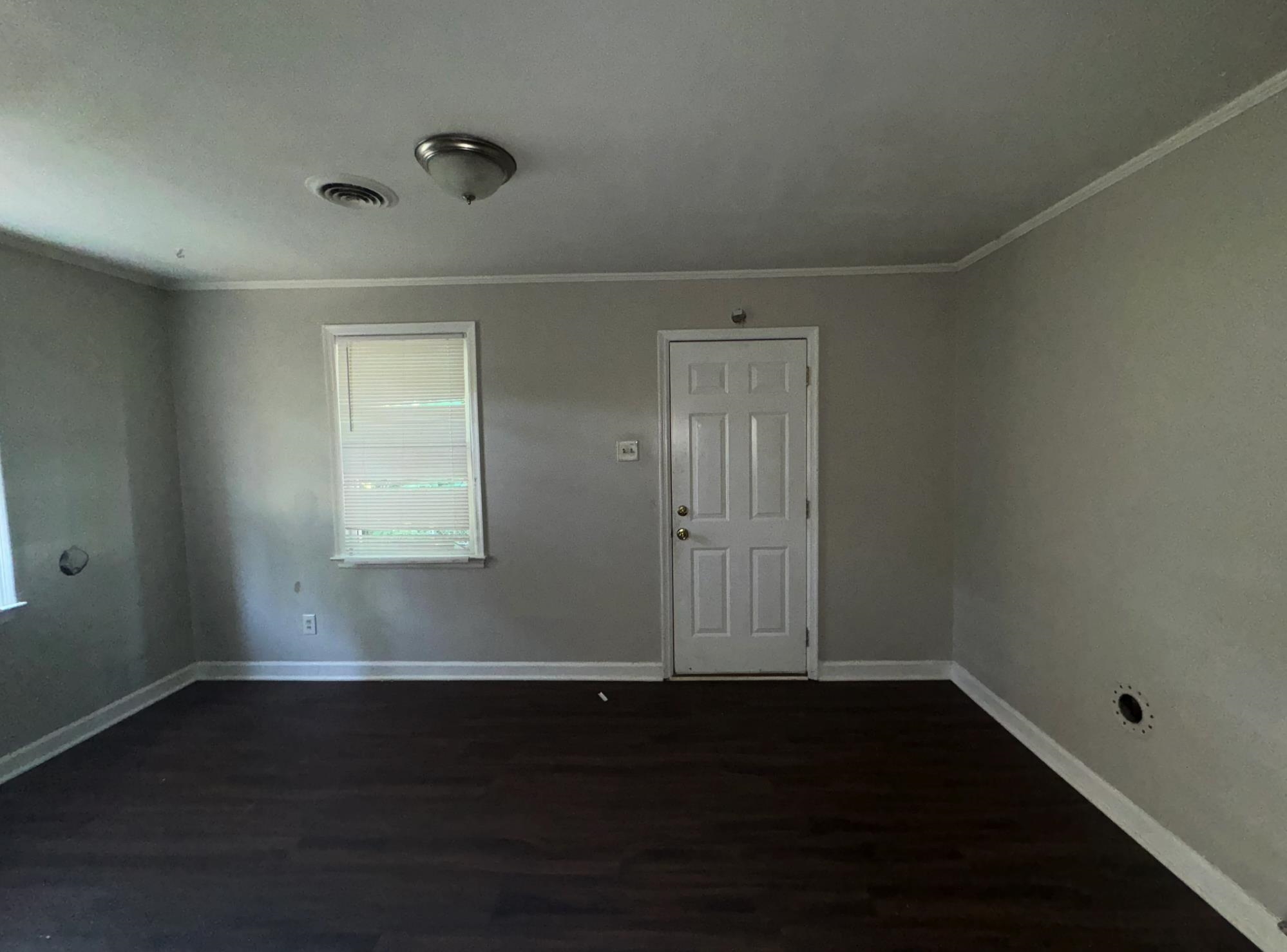 1058 Berclair Road Memphis, TN 38122 - Photo 3 of 8 Empty room featuring wood-type flooring and ornamental molding