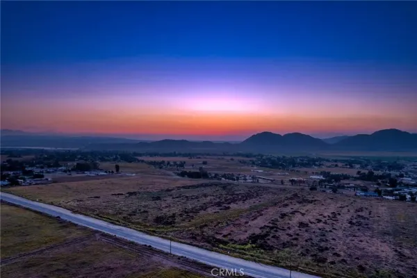 a view of a street with a yard