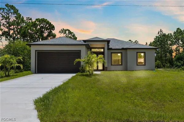 a front view of a house with a yard and garage