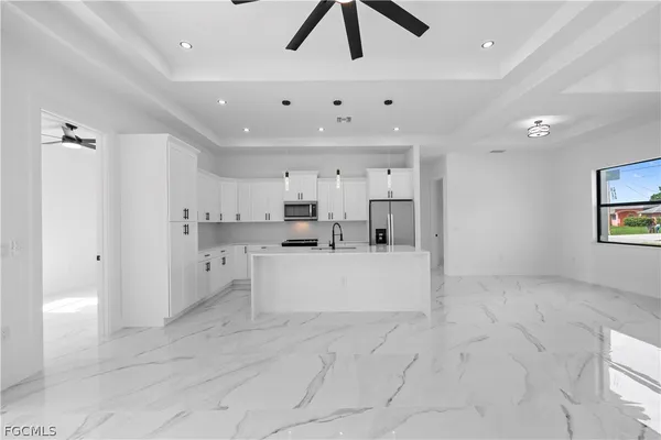 a kitchen with stainless steel appliances granite countertop a sink and a stove