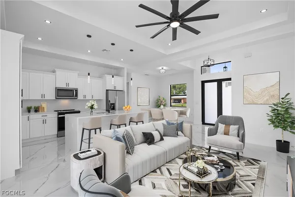 a living room with furniture kitchen view and a chandelier