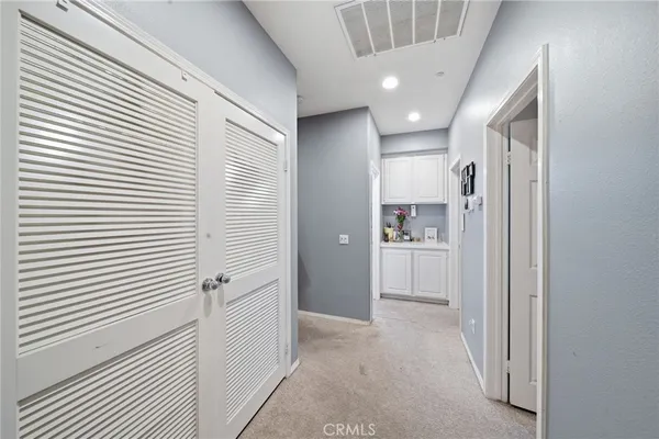a view of a hallway with a kitchen