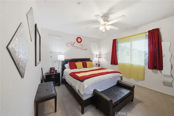 a bedroom with a bed couch and window