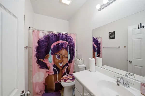 a bathroom with a sink mirror vanity and toilet