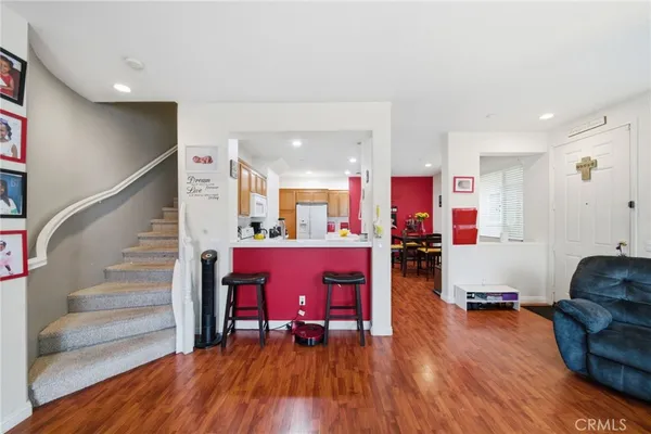 a living room with furniture and a wooden floor