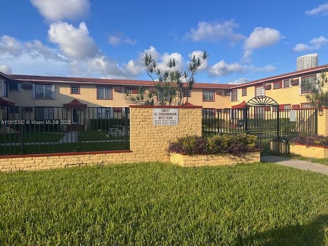 a view of a house with backyard and sitting area