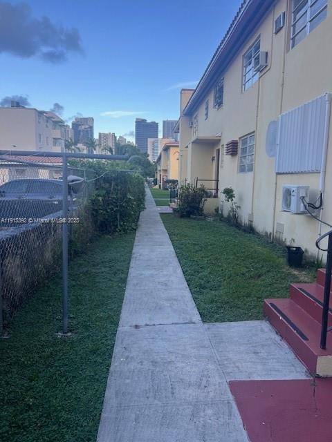 651 Southwest 11th Street, Unit 15W Miami, FL 33129 - Photo 20 of 24 a front view of a house with yard